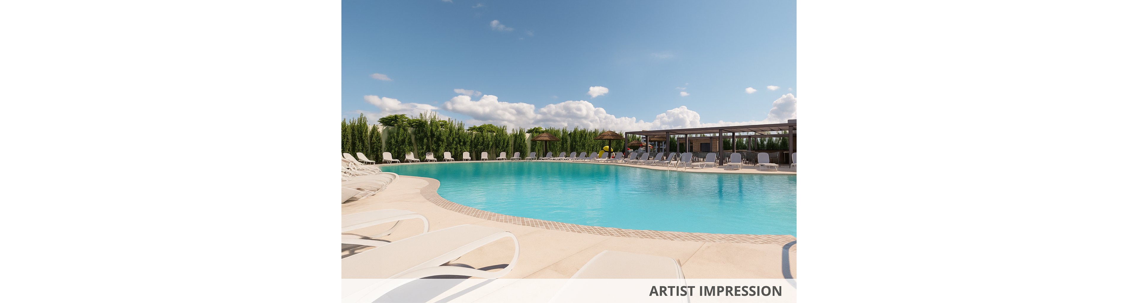 A large, curved swimming pool is surrounded by white lounge chairs under a bright blue sky. The pool area is framed by tall green hedges and a modern poolside building with shaded seating. Calm water reflects the sunlight, creating a relaxing resort atmosphere. Fluffy clouds and clear weather emphasize a warm, inviting outdoor setting.