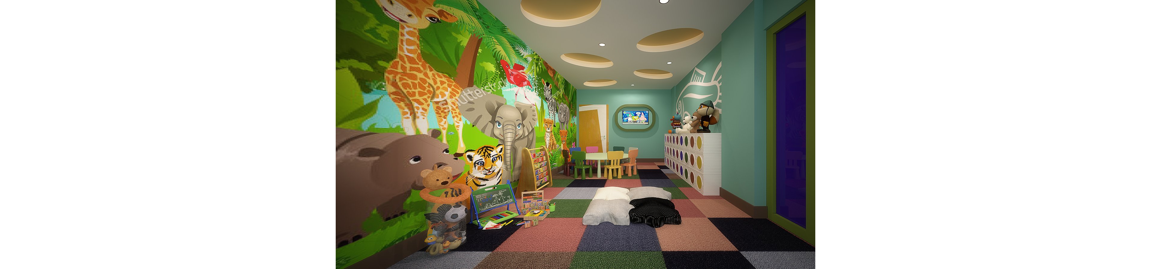 Bright children's playroom decorated with large jungle animal murals featuring giraffes, elephants, tigers, and hippos. The room includes a small table with chairs, floor cushions, and various toys and books arranged neatly. A wall-mounted screen is visible at the far end, adding a digital entertainment element. Soft ceiling lights and multicolored checkered flooring create a playful and inviting atmosphere.