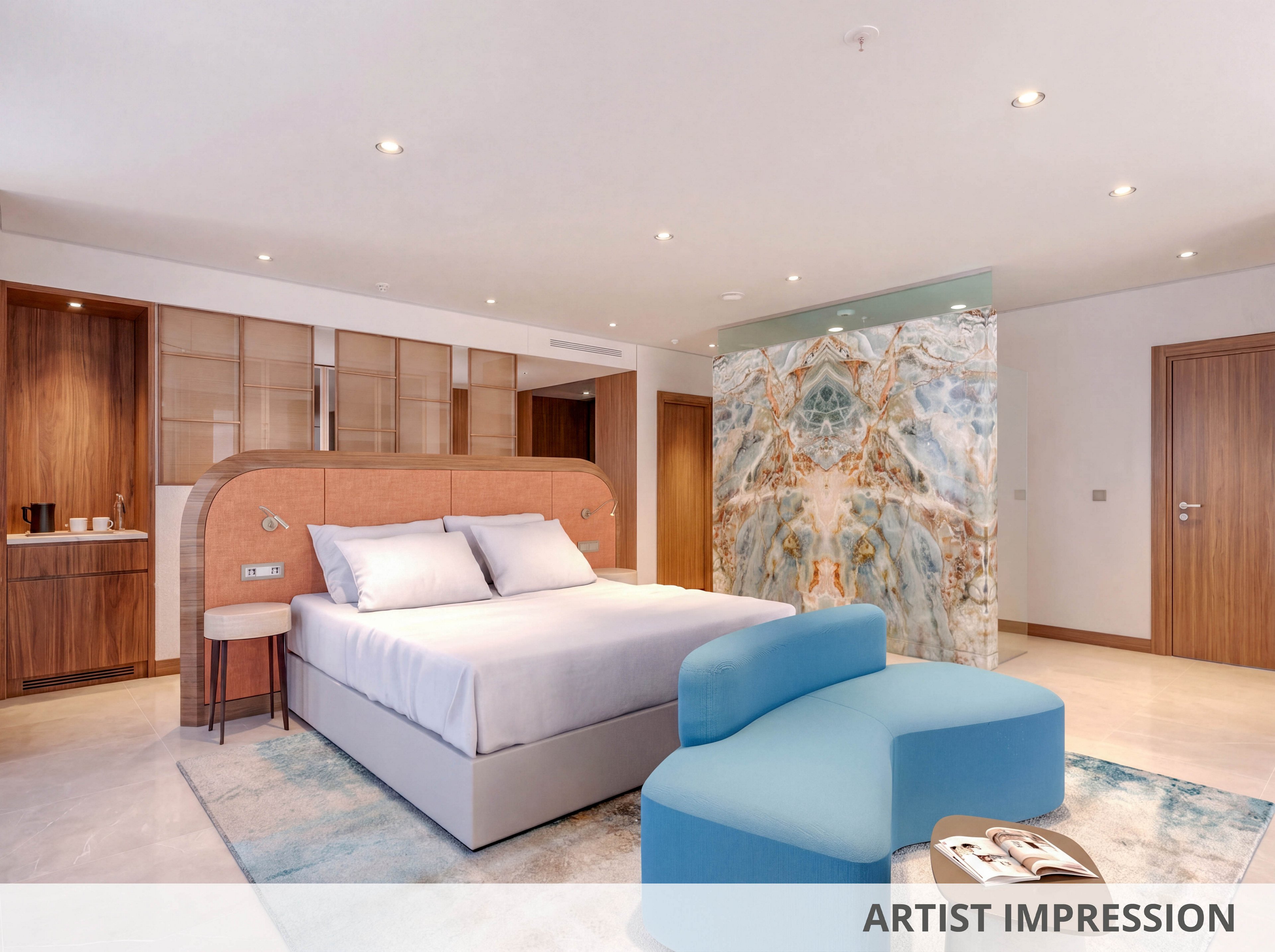 Contemporary hotel-style bedroom featuring a large double bed with upholstered headboard and crisp white linens. The room includes wooden doors and cabinetry, a small refreshment area, and a sculptural blue lounge chair. A striking marble-like accent wall adds texture and visual interest to the neutral interior. The text "ARTIST IMPRESSION" appears along the bottom edge of the image.