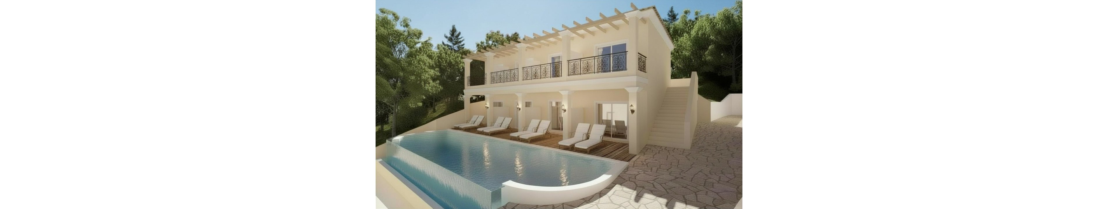 A contemporary two-story villa sits on a hillside with a large infinity-edge swimming pool in the foreground. Multiple white lounge chairs line the wooden deck beside the pool, suggesting a relaxing outdoor leisure area. The house features cream-colored walls, decorative balcony railings, and a pergola-style roof detail. Surrounding trees and greenery create a secluded, resort-like atmosphere under bright daylight.