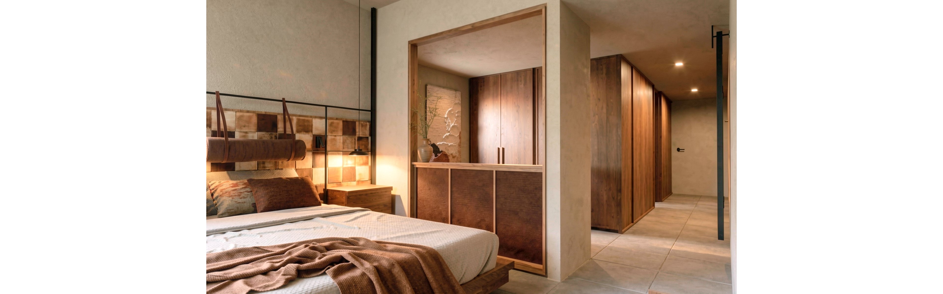 A contemporary bedroom features a neatly made bed with neutral bedding and a brown throw blanket. Warm wooden panels and cabinetry extend into a hallway with built-in closets, creating a cohesive interior design. Soft, indirect lighting and earthy colors give the space a calm, inviting atmosphere. Decorative wall art and simple furnishings emphasize a minimalist, natural aesthetic.