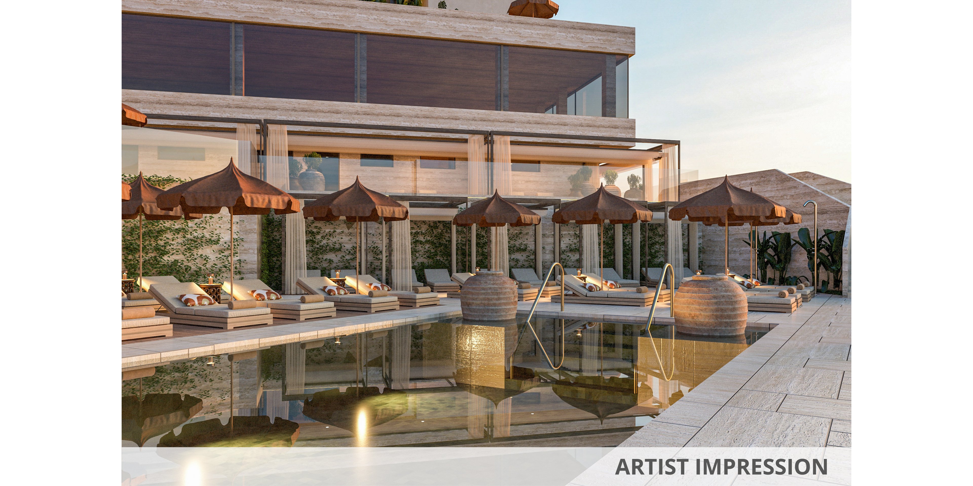 A modern outdoor swimming pool is surrounded by cushioned sun loungers and brown parasols on a stone terrace. The scene features a contemporary building with large glass windows and warm-toned stone walls in the background. Reflections of the umbrellas and railings appear on the calm pool water, enhancing the tranquil atmosphere. Soft evening light creates a relaxed, upscale resort ambiance.