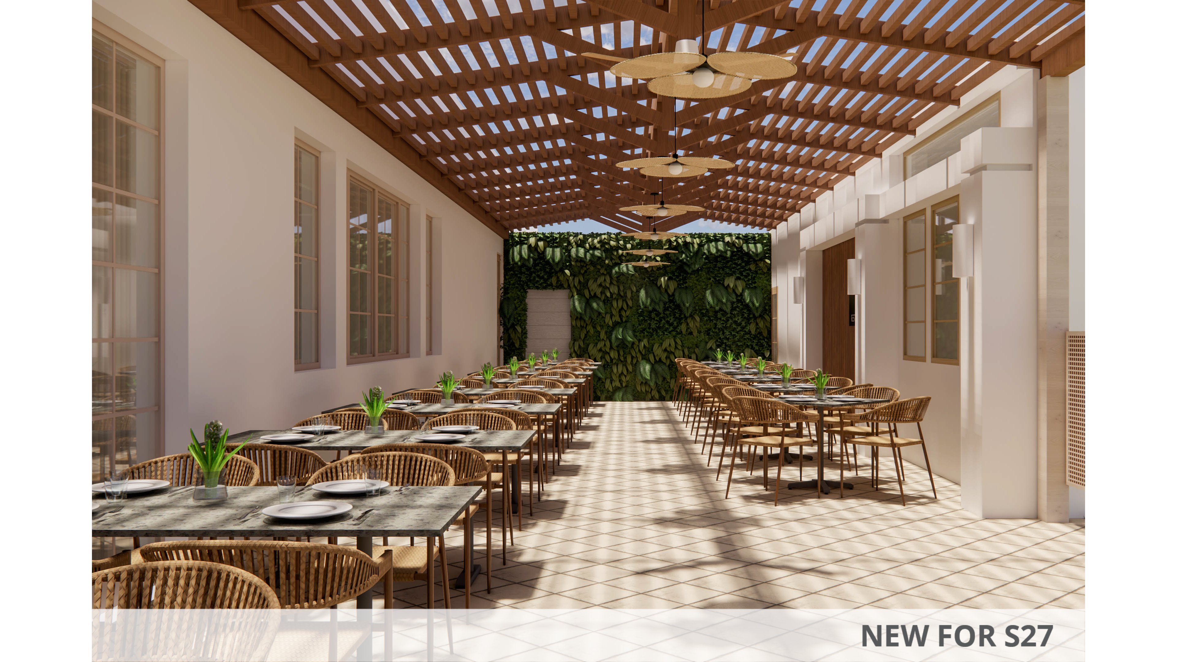 Image of an open-air restaurant terrace arranged with multiple rows of dining tables and wicker chairs. A wooden pergola overhead casts patterned shadows onto the tiled floor, creating a warm and inviting atmosphere. The setting is framed by light-colored building walls with large windows on one side and a green plant-covered wall at the far end. Table settings with plates and small potted plants add detail to the calm, contemporary dining space.