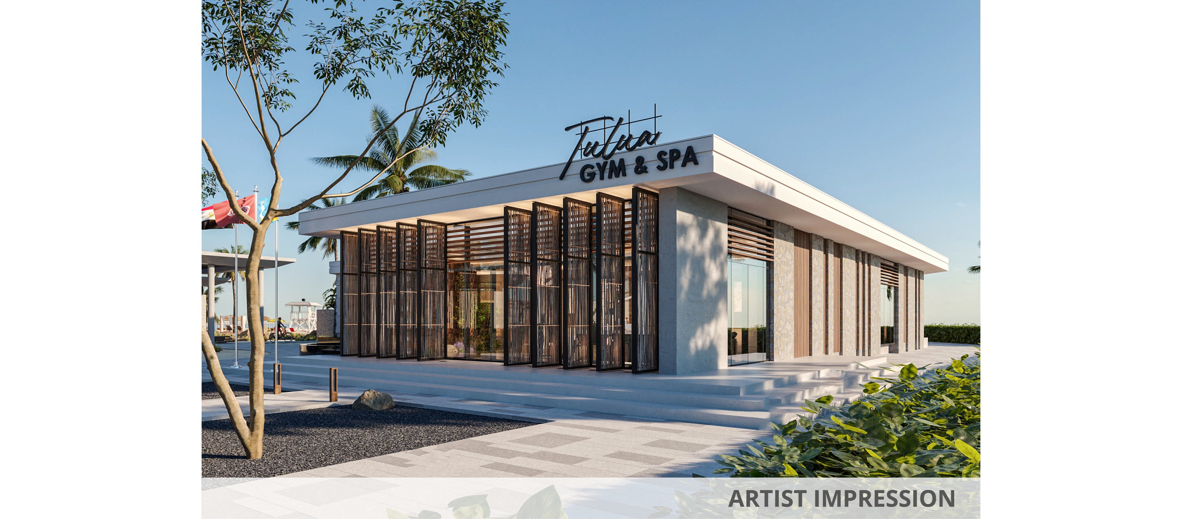 Contemporary single-story building labeled "Tulia GYM & SPA" stands in a sunny outdoor setting. The structure features large floor-to-ceiling glass windows, vertical wooden slats, and clean white architectural lines. Palm trees, landscaped greenery, and a clear blue sky create a relaxed, resort-like atmosphere. The wide paved walkway and open plaza emphasize the inviting entrance to the wellness facility.