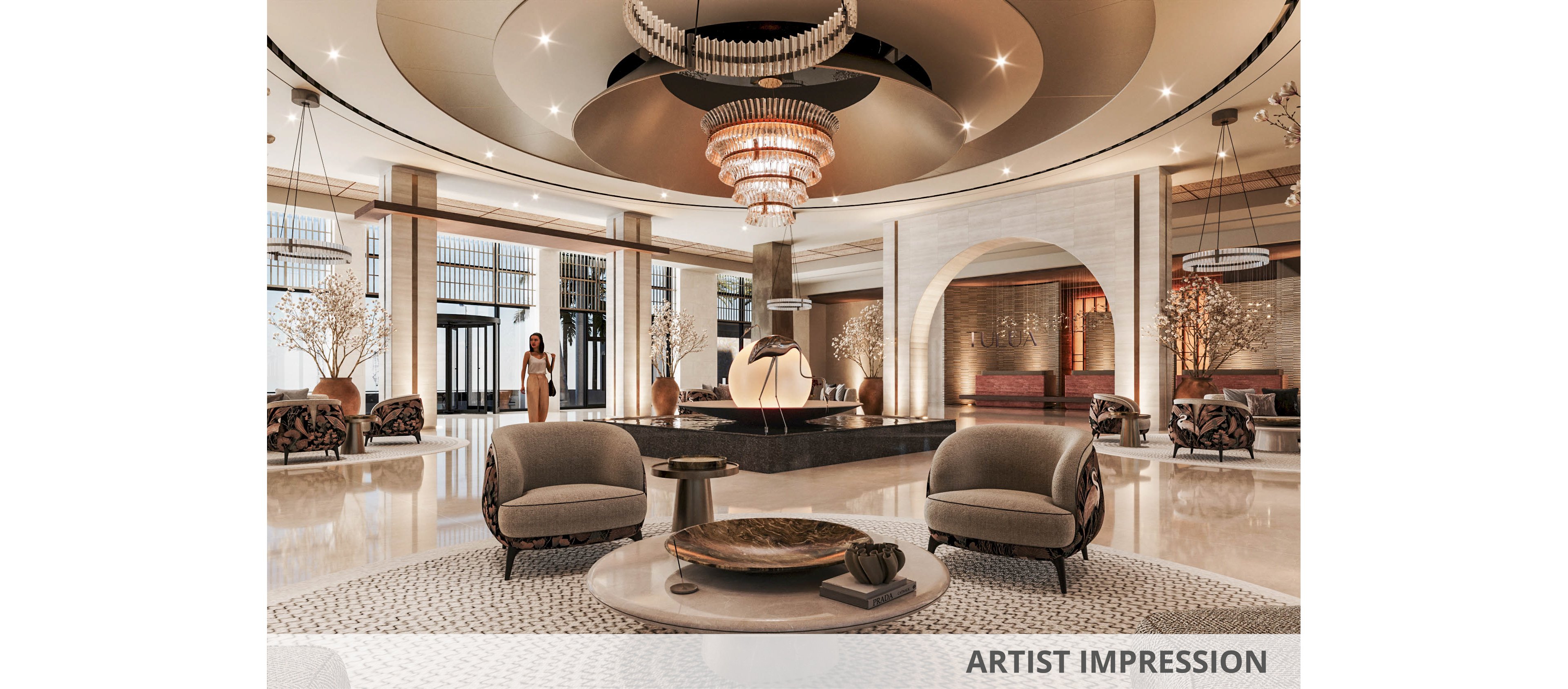 Spacious, upscale hotel lobby featuring plush seating and a dramatic central chandelier. Warm neutral tones, polished floors, and soft lighting create an elegant, welcoming atmosphere. Decorative trees, sculptural elements, and contemporary furniture add sophistication to the interior design. A few people are seen in the background, enhancing the sense of scale and liveliness.