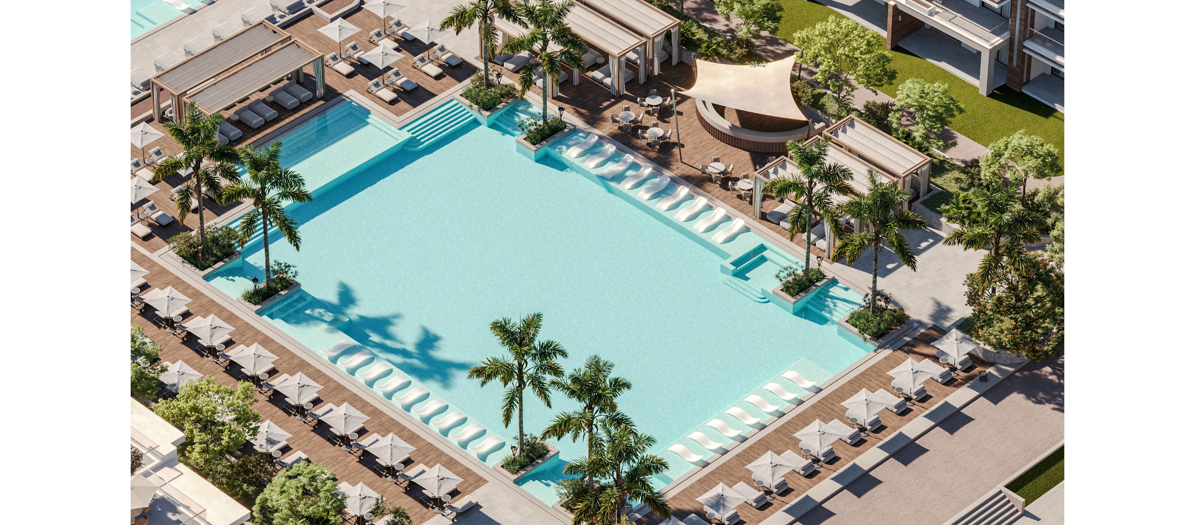A large, turquoise swimming pool is surrounded by sun loungers and cabanas in a modern resort setting. Palm trees are planted around the pool, adding a tropical atmosphere. Shallow in-water loungers line one side of the pool, while shaded seating and a curved canopy bar area appear nearby. The scene is bright and sunny, suggesting a relaxing vacation environment.