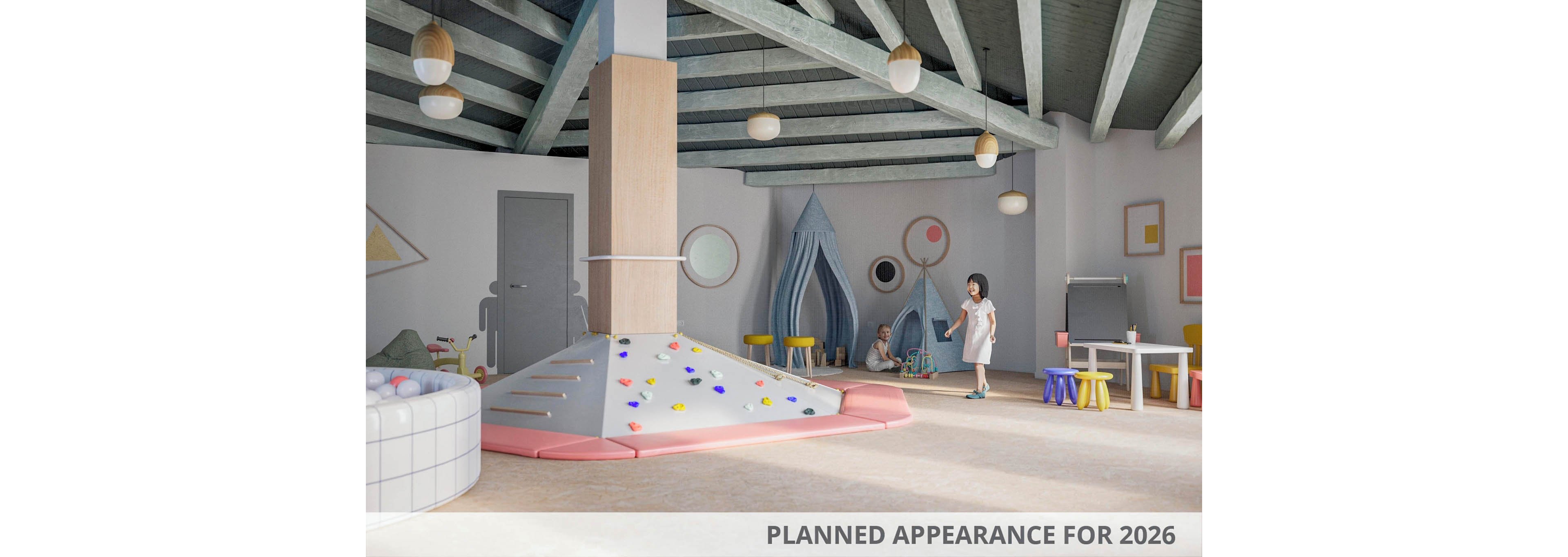 A spacious indoor playroom featuring a climbing structure, soft seating, and creative play areas. The setting includes pastel tones and geometric designs, with children engaging in play activities. Visible text indicates 'Planned Appearance for 2026,' highlighting a future concept.