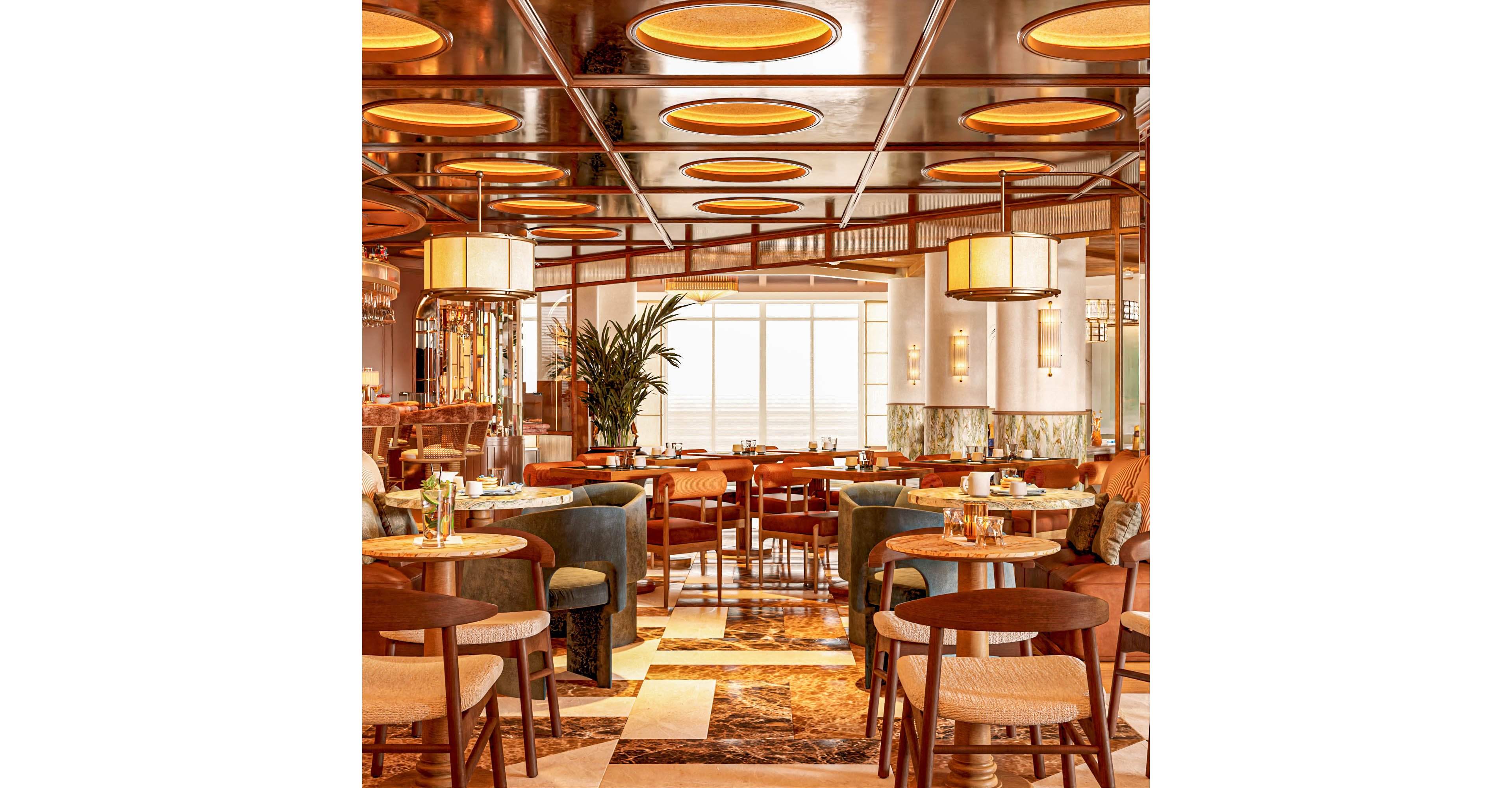 Upscale restaurant dining room featuring modern wooden tables and upholstered chairs arranged neatly across a patterned marble floor. The space is illuminated by large circular ceiling lights and pendant fixtures that create a warm, golden glow. Floor-to-ceiling windows at the back brighten the room, while decorative plants and polished metal accents add sophistication. Table settings with glassware and plates suggest a prepared, welcoming environment for guests.