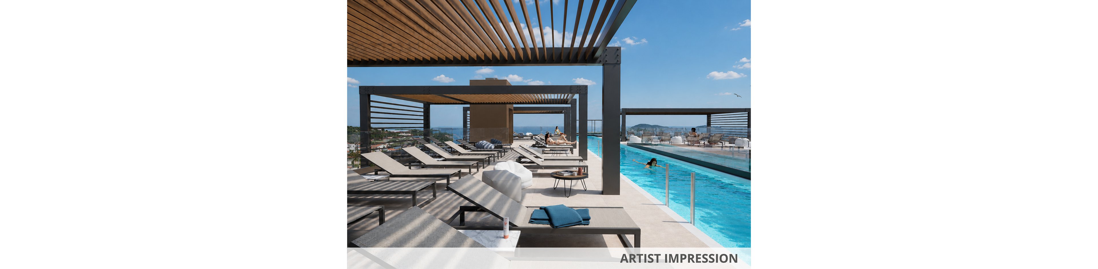 Artist impression of a contemporary rooftop pool area featuring multiple reclining sun loungers under sleek pergola structures. A long, narrow swimming pool runs along the deck, with people relaxing in the water and on chairs. Towels and a small tube of product rest on a lounger, adding lifestyle detail to the scene. The setting is bright and sunny with blue skies, distant cityscape views, and a relaxed resort atmosphere.