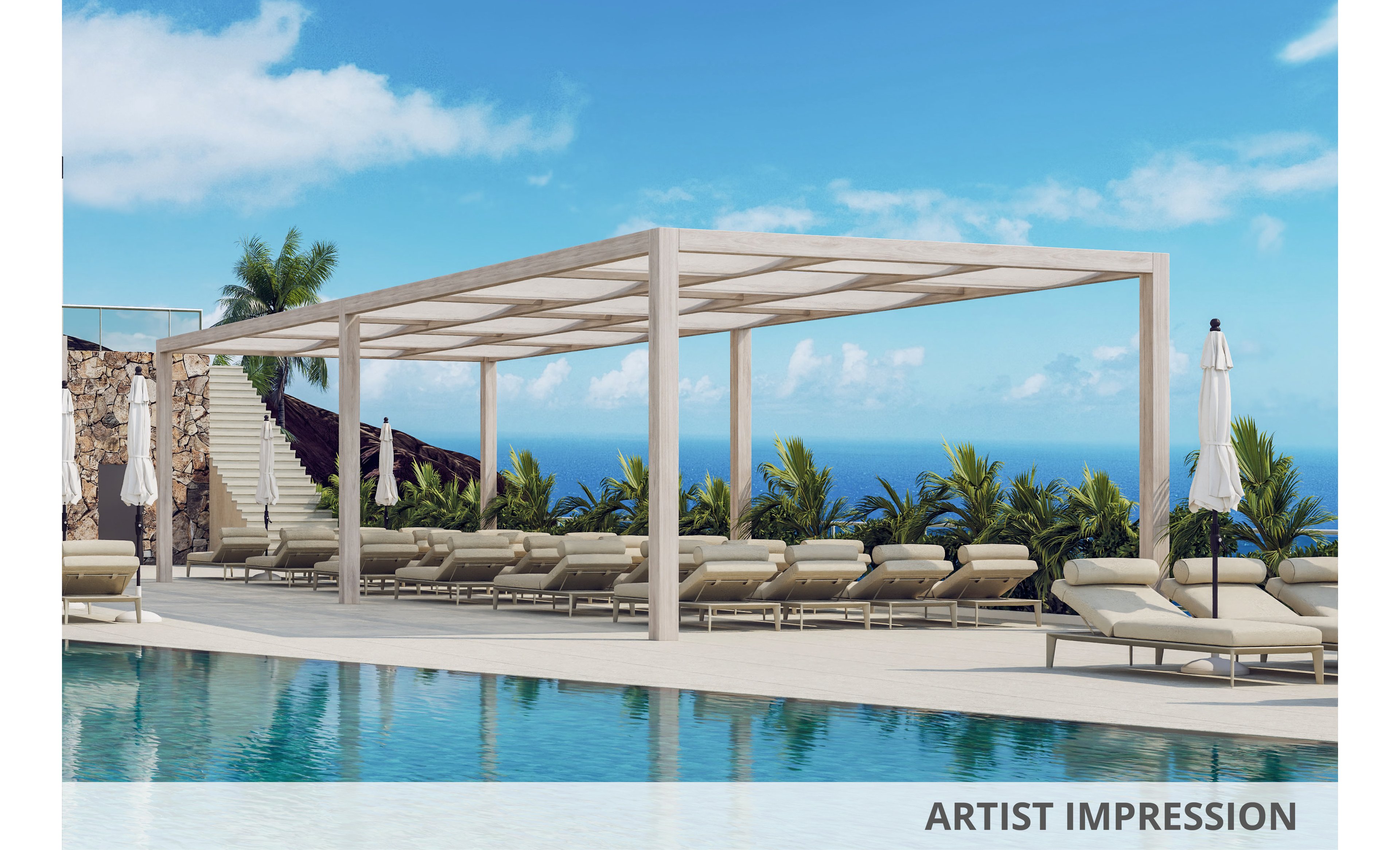 A contemporary outdoor pool area features a row of cushioned sun loungers beneath a minimalist pergola structure. White umbrellas and tropical palm plants frame the deck, creating a resort-style atmosphere. Clear blue water in the foreground reflects the bright sky, while the ocean is visible in the distance. Stone walls and stairs on the side add texture and lead up from the pool terrace.