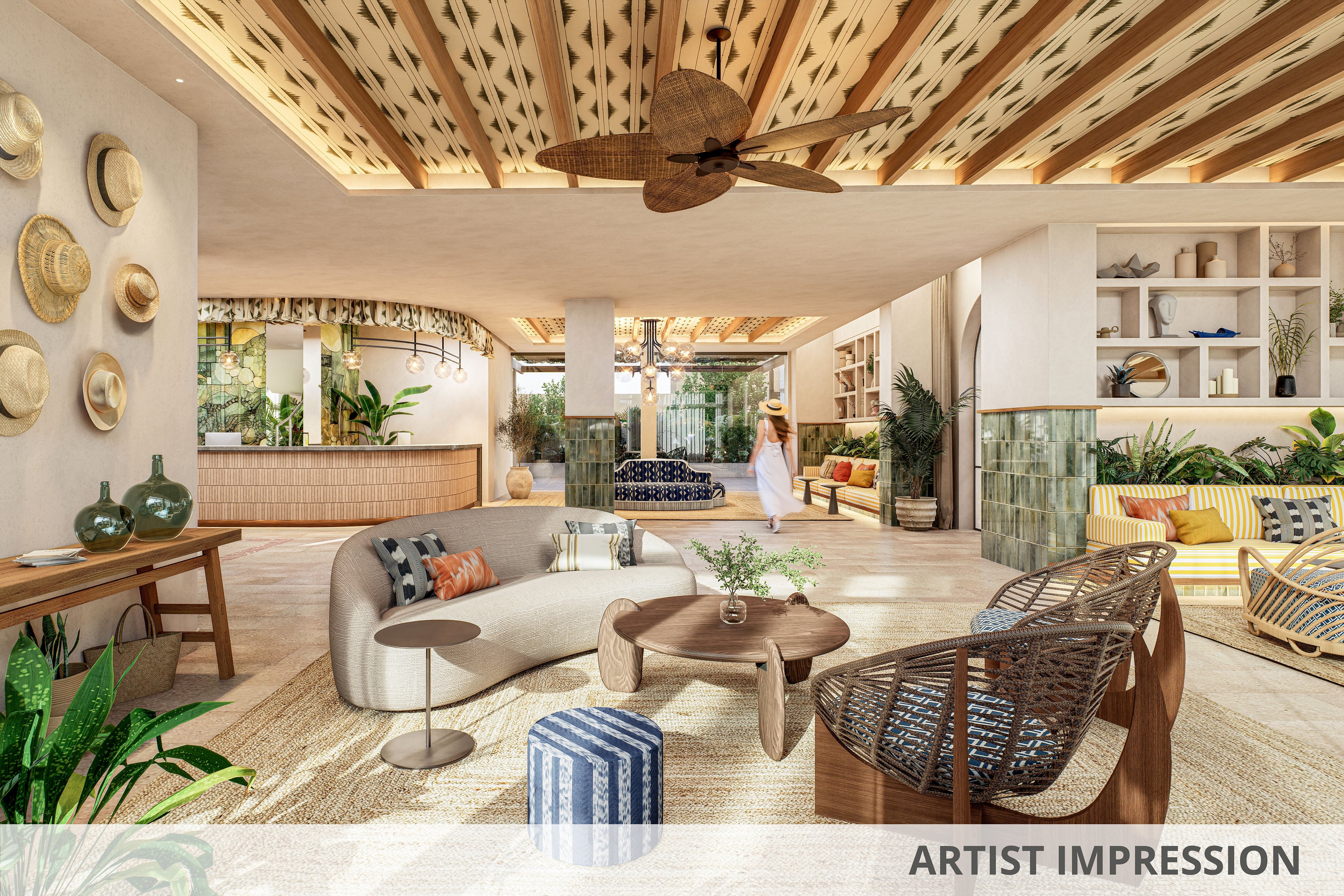 Spacious hotel lobby lounge with modern tropical decor and natural materials. A curved sofa, woven armchairs, and patterned ottomans sit on a large textured rug around a wooden coffee table. The ceiling features decorative wooden beams and a fan, while shelves and walls display plants, pottery, and hanging hats. Warm neutral tones are accented by colorful cushions and greenery, creating a relaxed vacation atmosphere.