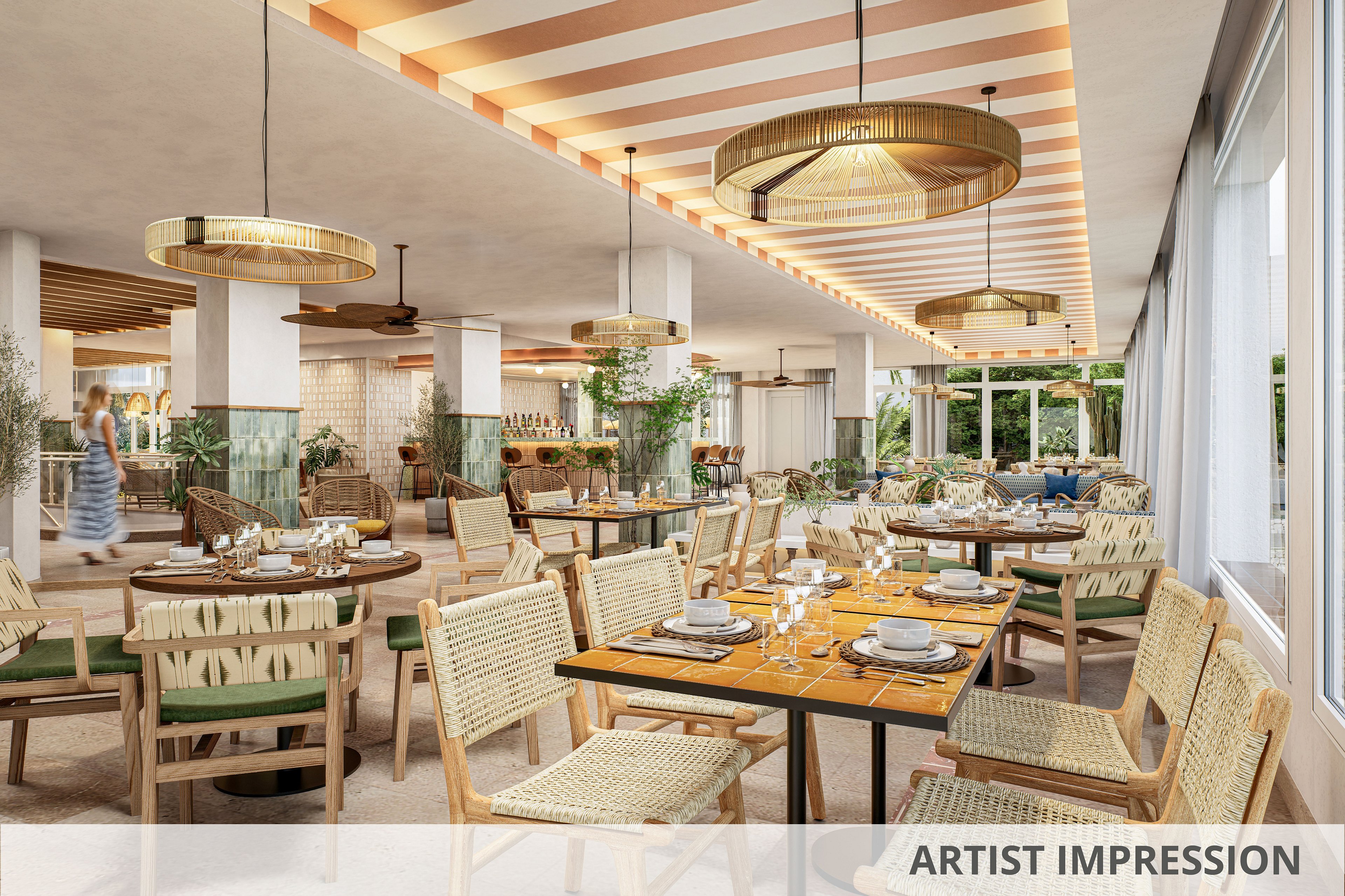 A spacious, modern restaurant interior features woven wicker chairs around wooden tables set with plates, glasses, and cutlery. Large circular pendant lights hang from a striped ceiling, casting warm light across the dining area. Green cushions, potted plants, and natural textures create a relaxed, tropical atmosphere. Floor-to-ceiling windows open to an outdoor view, enhancing the airy and inviting setting.