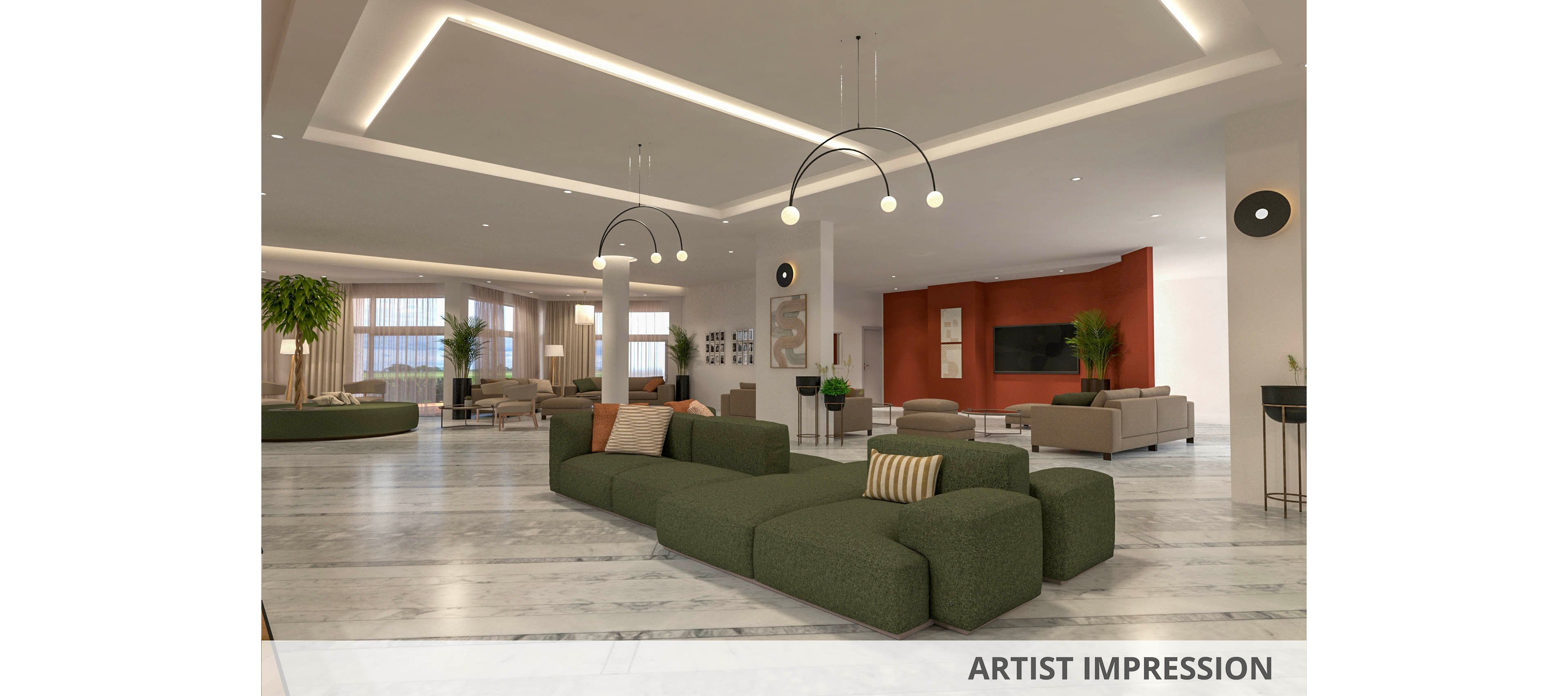A spacious, contemporary hotel lobby features modular green sectional sofas arranged on a polished marble floor. The setting includes large windows, indoor plants, and a bold red accent wall with a mounted television. Minimalist pendant lighting and neutral decor create a welcoming, upscale atmosphere. No visible text or numbers are present in the image.