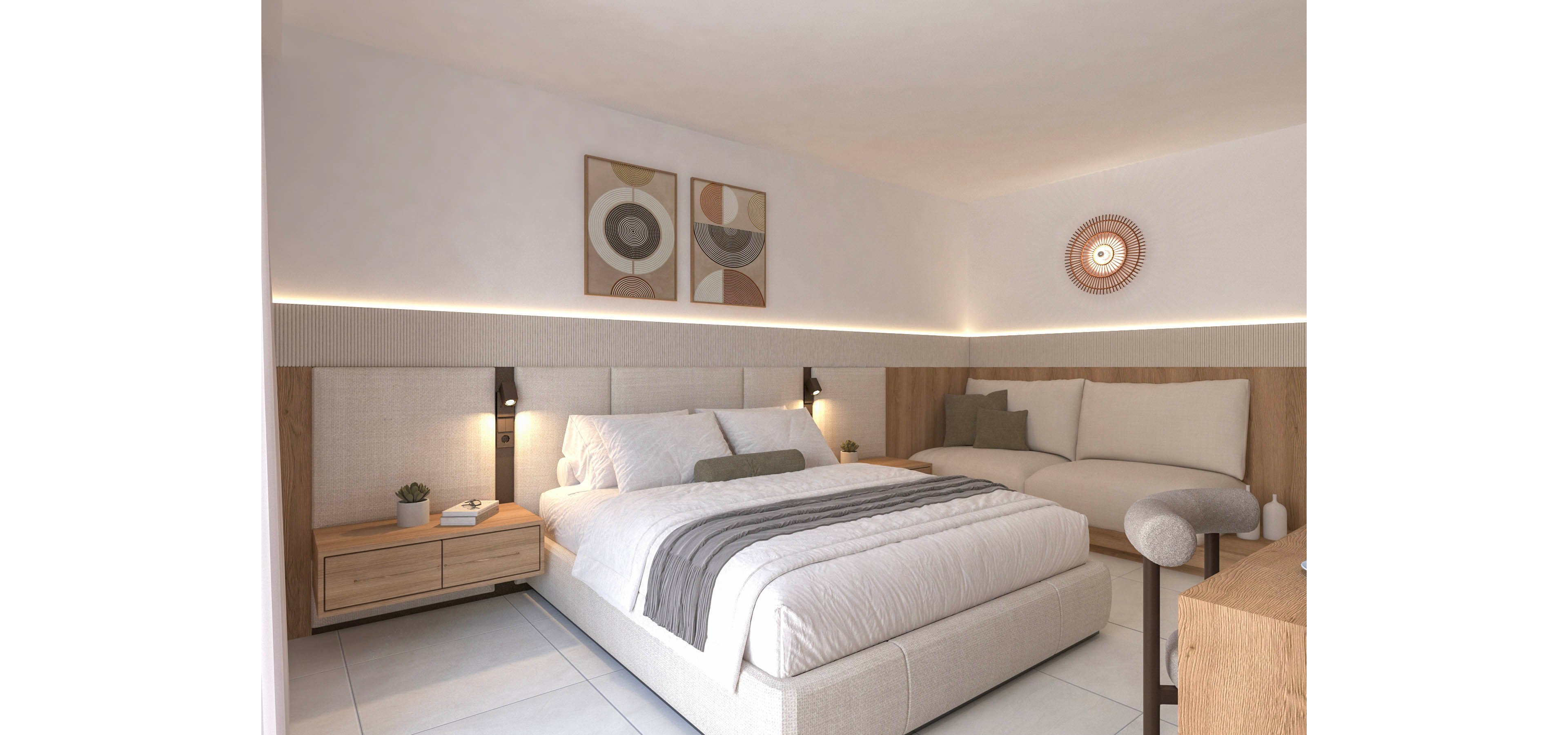 Contemporary bedroom with a large upholstered bed and neutral bedding is shown in a bright, minimalist setting. A wooden nightstand with small decor items and plants sits beside the bed, while a cushioned bench and sofa complete the seating area. Soft indirect LED lighting runs along the wall, highlighting geometric artwork and a round decorative wall piece. The overall palette is light and warm, emphasizing comfort and modern style.
