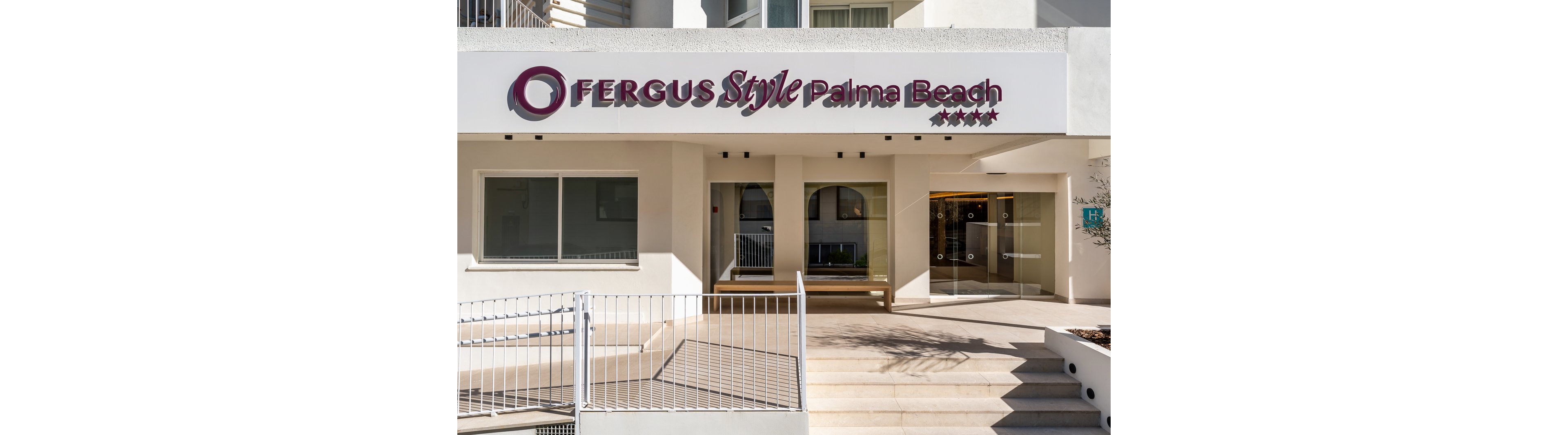 The image shows the main entrance of Fergus Style Palma Beach hotel, featuring a modern white facade with clear signage above the doorway. The setting is outdoors, with steps leading up to the entrance and glass doors visible. Four stars are displayed next to the hotel name, indicating its rating. The overall mood is clean and contemporary, with neutral tones and bright natural lighting.