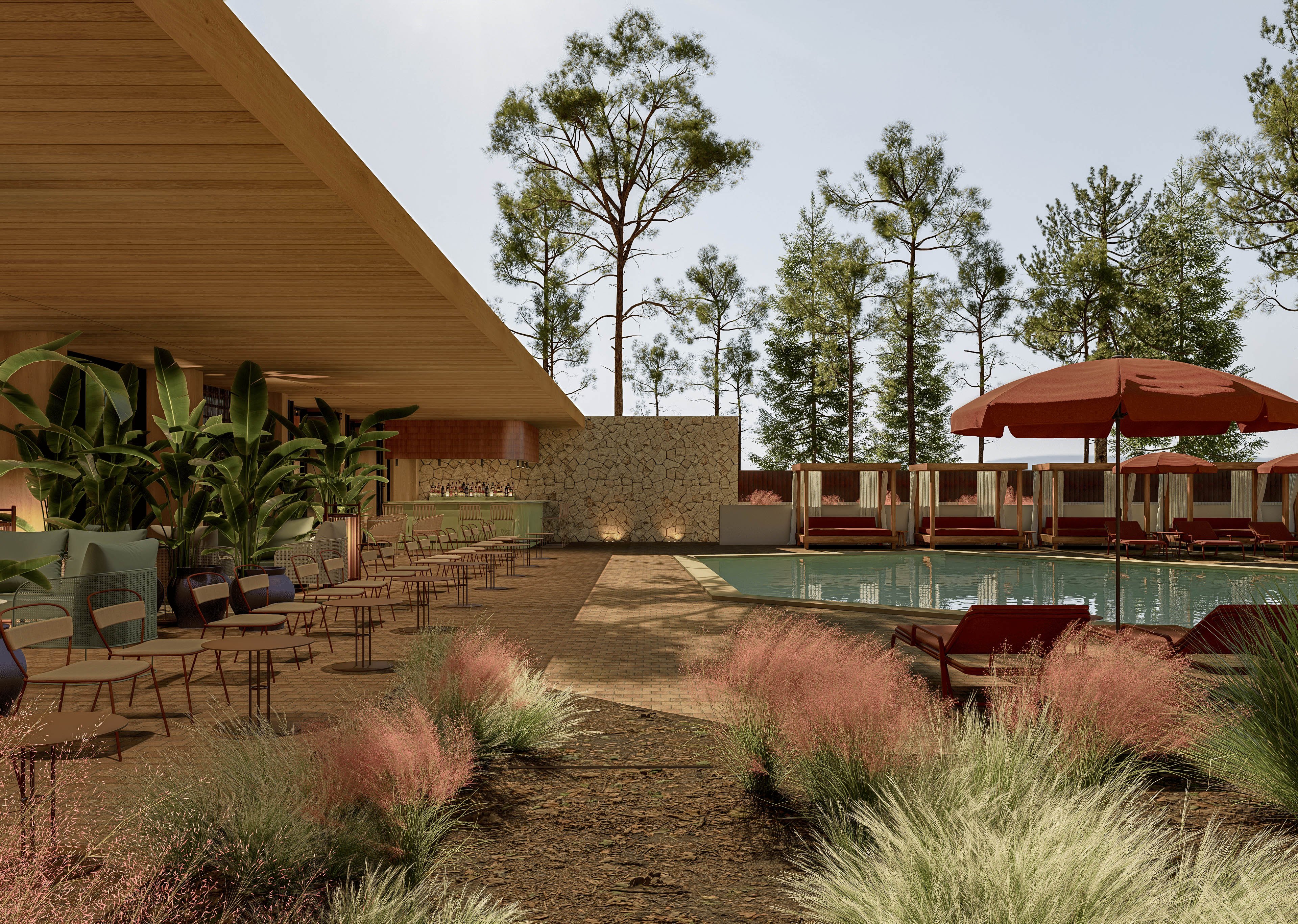 A contemporary outdoor lounge features a swimming pool surrounded by seating and lush plants. The space includes shaded cabanas with red umbrellas and a long row of chairs and tables under a wooden canopy. Tall trees and ornamental grasses frame the area, creating a natural backdrop. Warm lighting and earthy materials give the setting a relaxed, resort-like atmosphere.