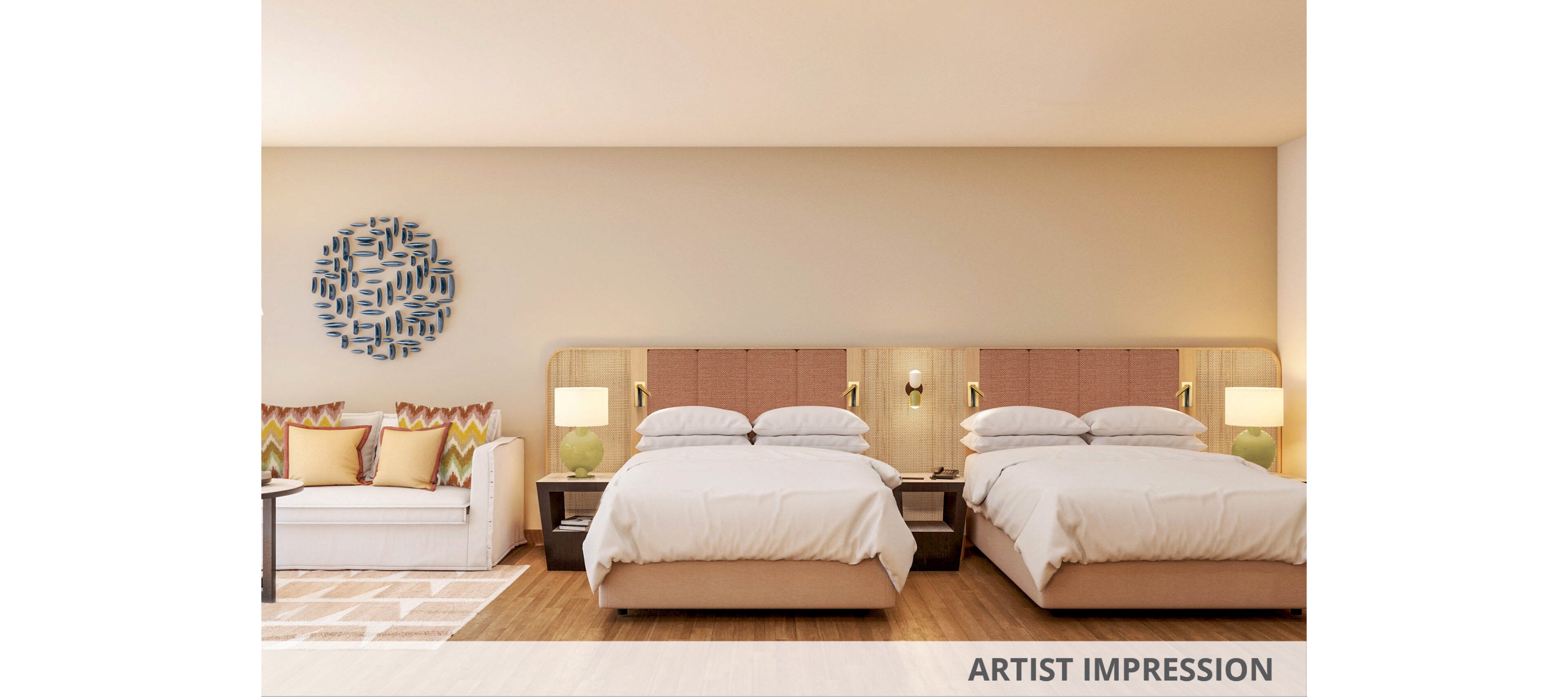 A contemporary hotel room features two neatly made double beds with padded headboards. A white sofa with colorful accent pillows sits to the left beside a small table. Warm bedside lamps and wall sconces create a cozy, inviting atmosphere. Wooden flooring, neutral walls, and a circular wall art piece complete the modern interior design.