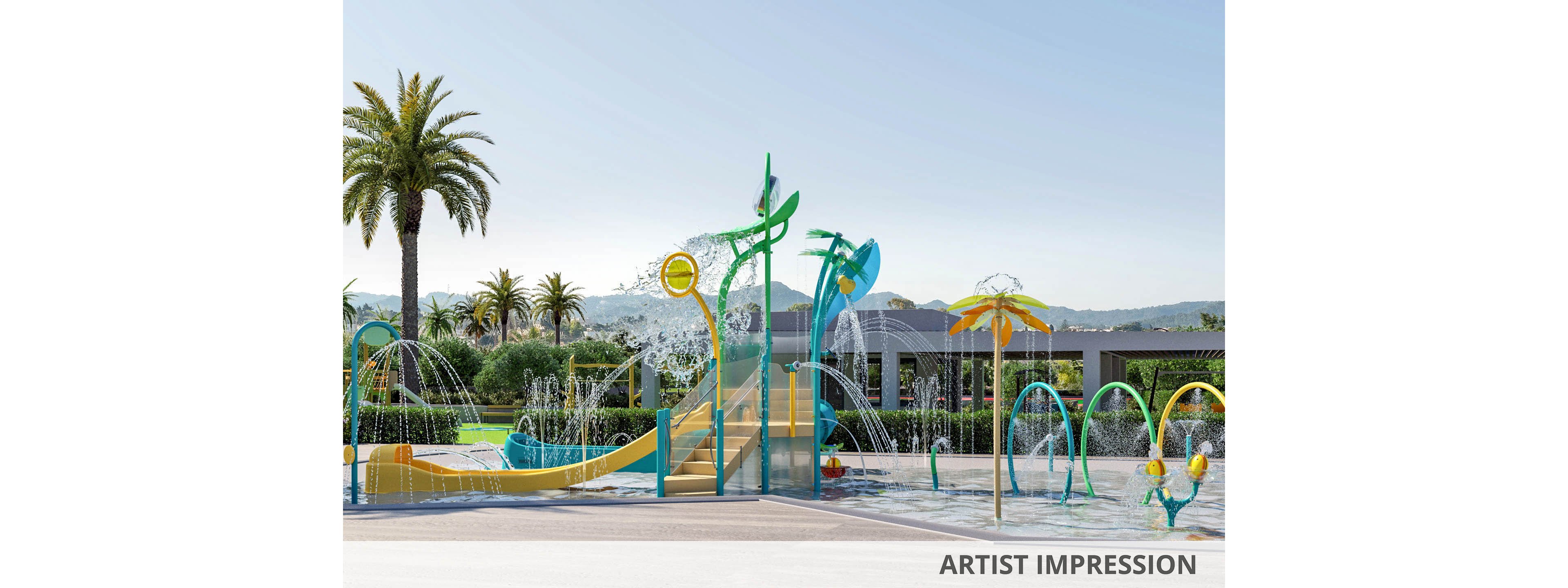 An outdoor splash pad features multiple colorful water play structures with sprays and fountains. Curved arches, tall sprayers, and palm-shaped elements create an engaging aquatic playground. The area is surrounded by greenery, palm trees, and low modern buildings under a clear sky. Bright yellow, green, and blue accents give the scene a fun, family-friendly atmosphere.