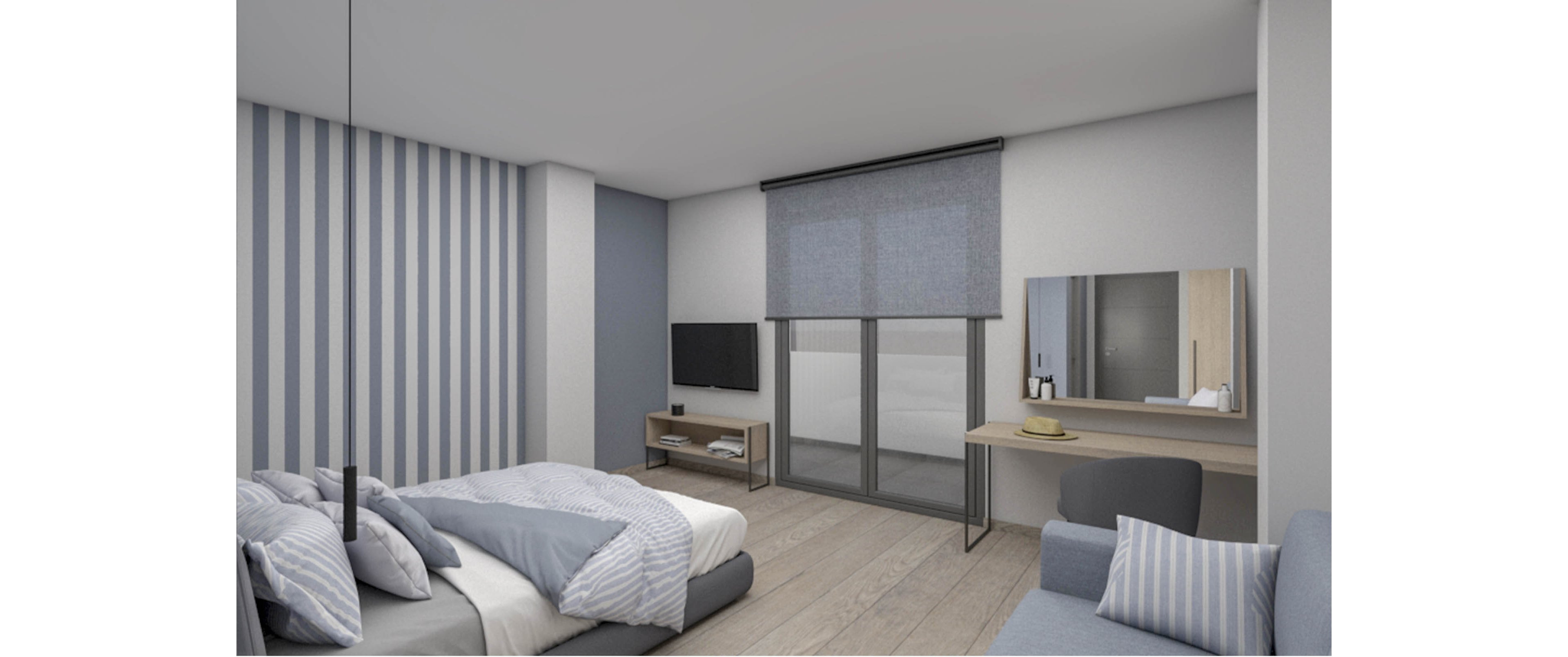 A contemporary bedroom features a neatly made bed with blue and white striped bedding and a matching accent wall. Large windows with grey roller blinds open onto a balcony or exterior view, bringing light into the space. A wall-mounted television sits above a low media console, while a desk with a mirror and chair creates a small workspace or vanity area. A sofa with coordinated cushions and light wood flooring complete the calm, minimalist interior.
