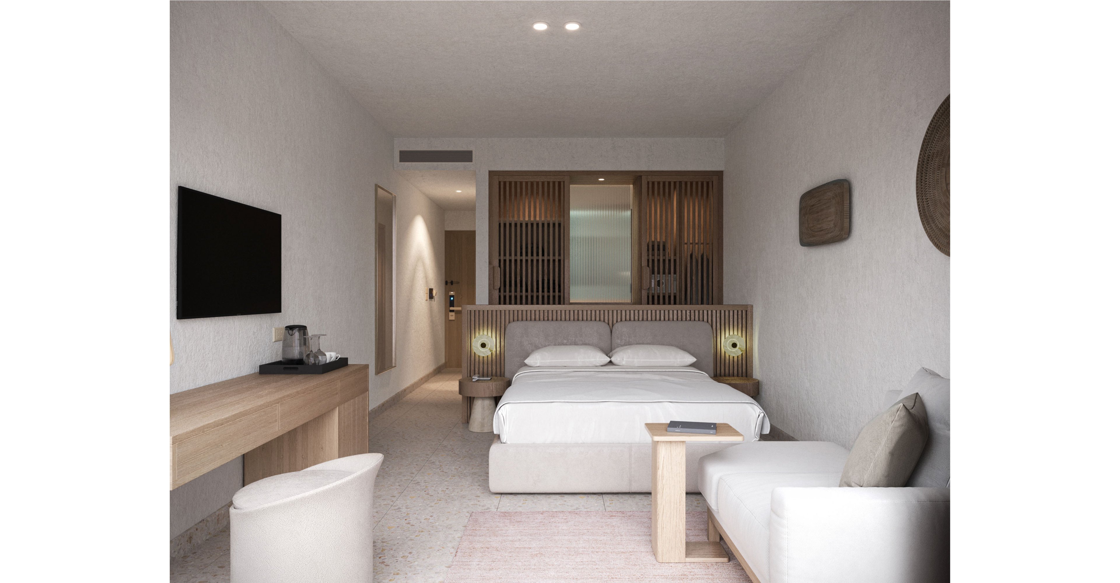 A contemporary hotel room features a neatly made double bed centered against a wooden slatted headboard. The space includes a wall-mounted flat-screen TV, a long wooden desk with a chair, and a small seating area with a sofa and side table. Soft neutral tones of beige, white, and light wood create a calm, minimalist atmosphere. Recessed ceiling lights and bedside lamps provide warm, ambient lighting in the clean, uncluttered space.