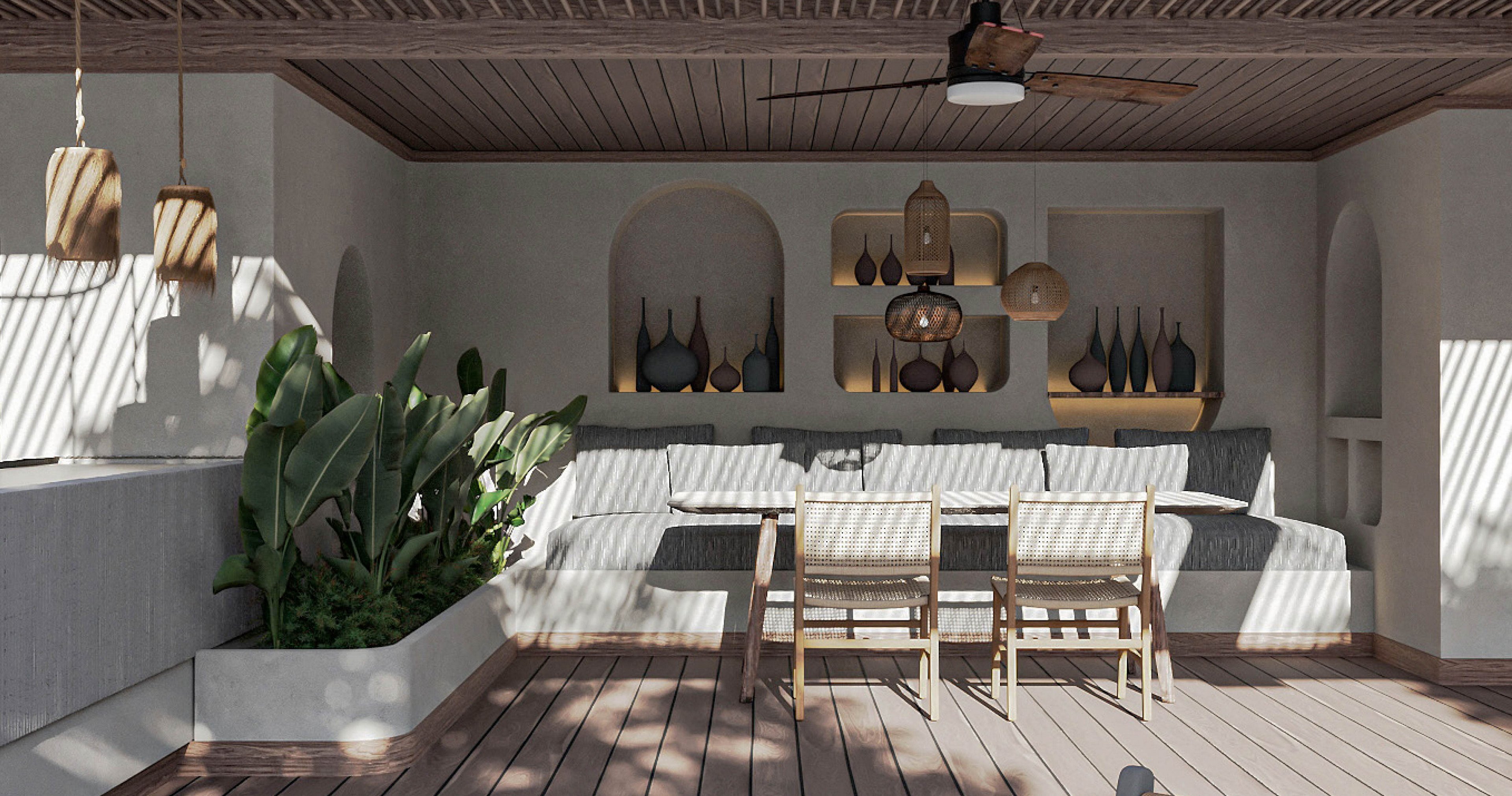 A contemporary outdoor lounge features a built-in cushioned sofa and a wooden dining table with four chairs. Decorative vases and pendant lights are arranged in recessed wall niches, adding visual interest to the neutral-toned space. Sunlight filters through a slatted wooden ceiling, casting shadows across the floor and furniture. A large potted plant softens the minimalist design and brings greenery into the seating area.