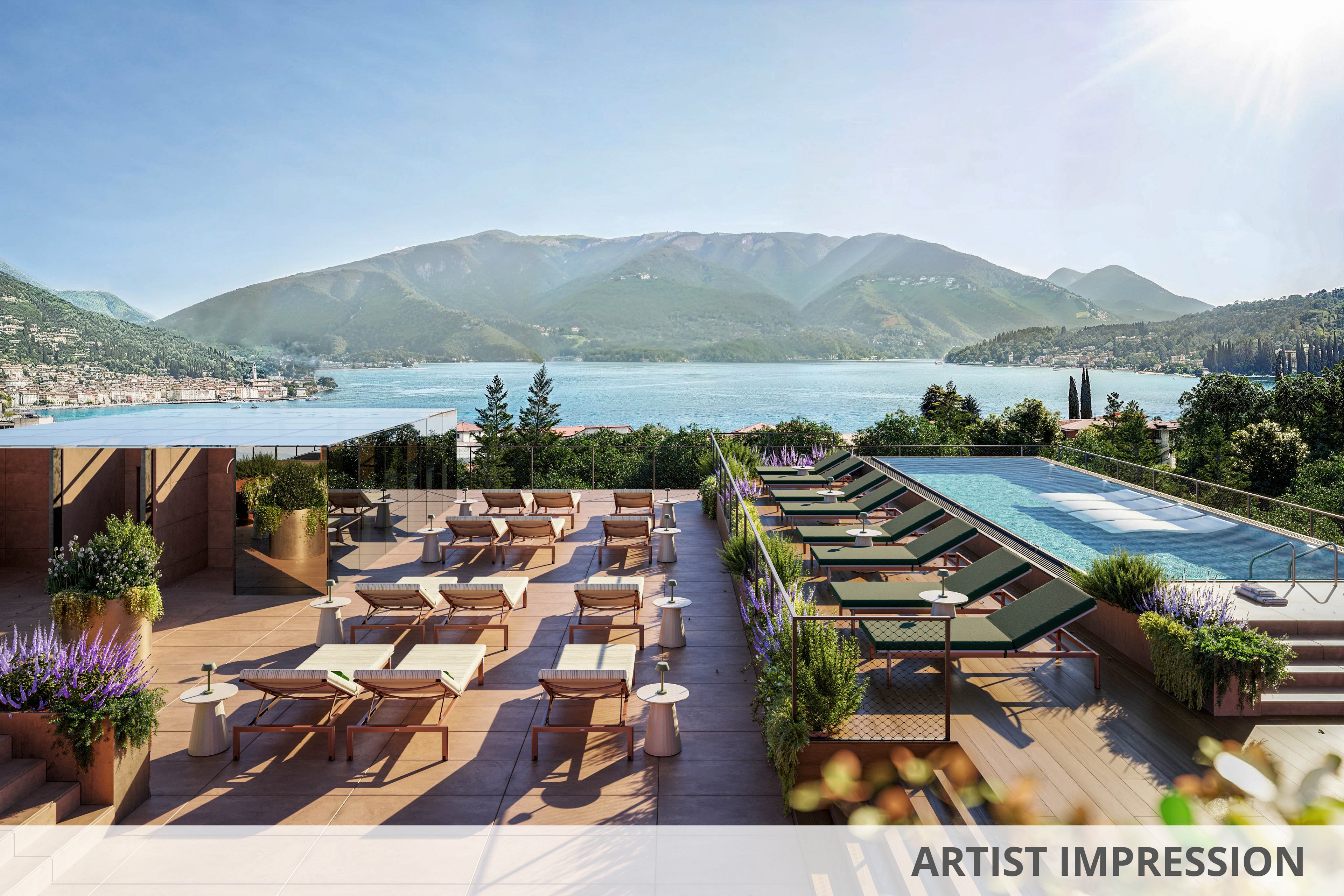 A modern rooftop terrace features a rectangular swimming pool with lounge chairs and sunbeds arranged neatly alongside. The setting overlooks a tranquil lake surrounded by lush green mountains, creating a relaxing and luxurious atmosphere. Potted plants and purple flowers add a touch of color to the warm, natural palette. The scene is bathed in daylight, with no visible people present.