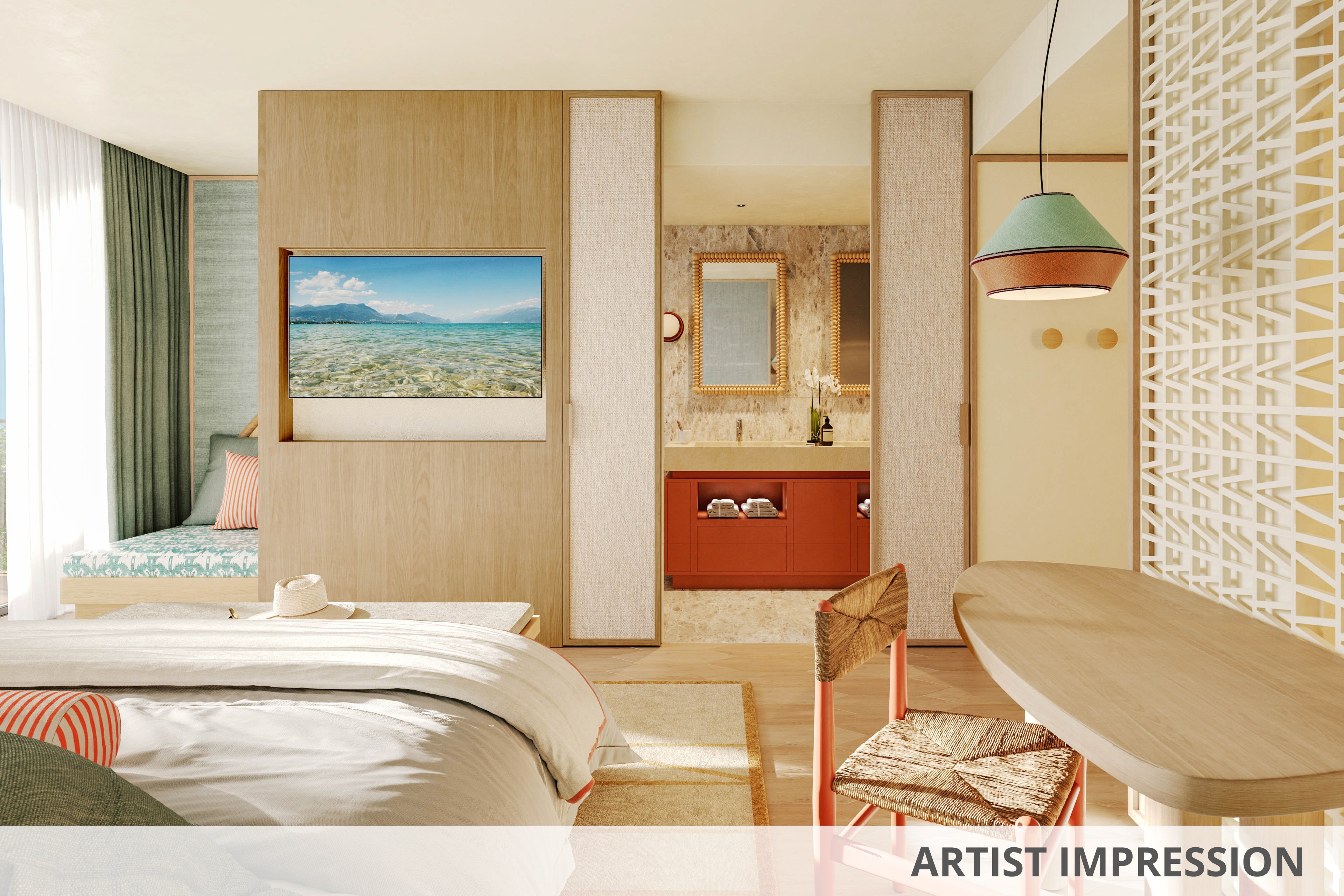 A contemporary hotel room features a large bed, a wooden table with a chair, and a window seat overlooking a scenic mountain landscape. The space is decorated in warm, neutral tones with natural light streaming in, creating a calm and inviting atmosphere. The bathroom area is visible in the background, separated by partial walls, and includes a mirror and vanity. Decorative pendant lighting and textured accents add to the modern, relaxed style.