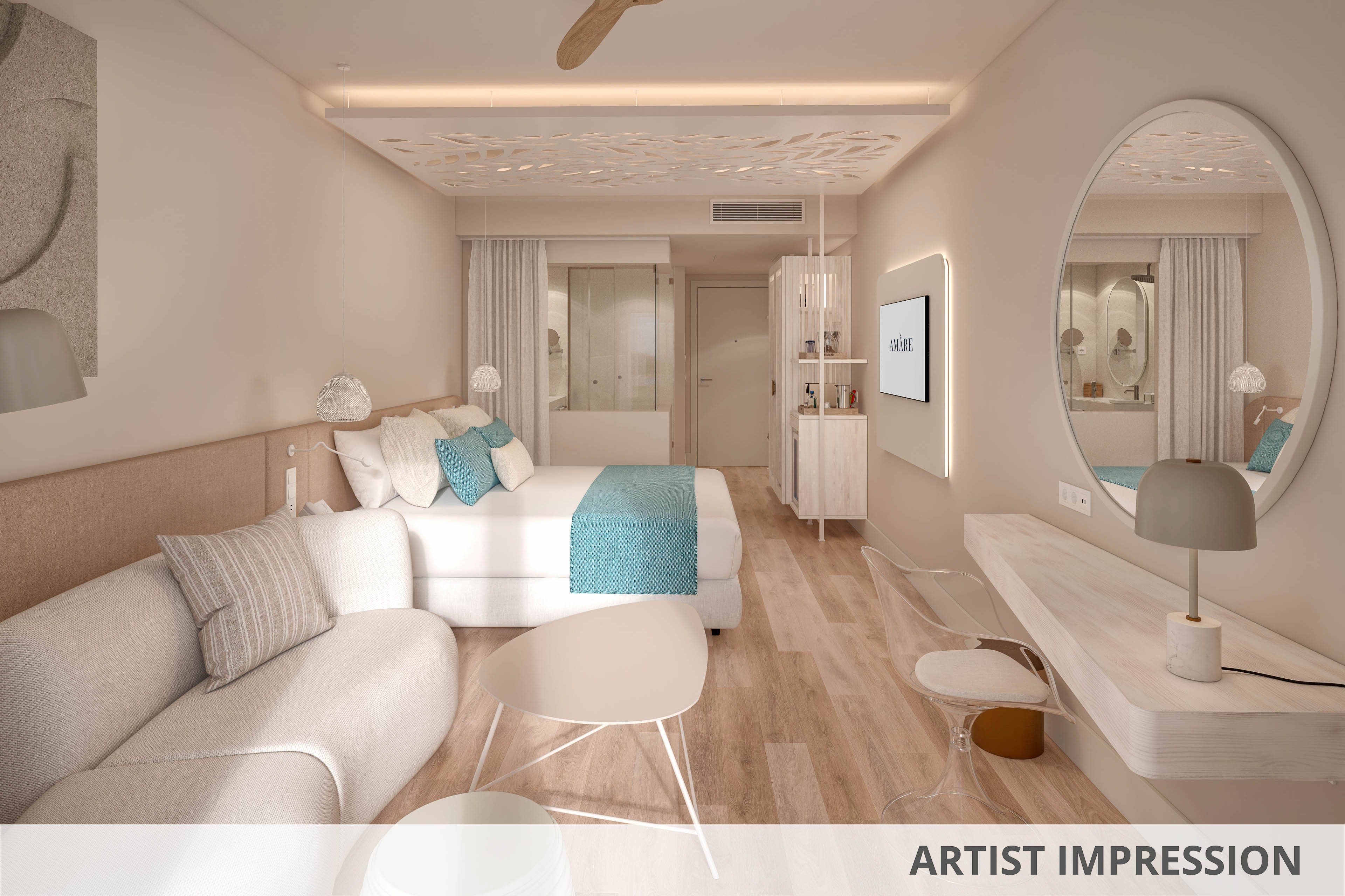 A contemporary hotel room features a large bed with white linens and turquoise accents, complemented by a light-colored sofa. The space is decorated in a soft neutral palette with wooden flooring and minimalist furniture, including round nesting tables and a sleek desk. A wall-mounted television and large circular mirror add to the modern aesthetic, while subtle ceiling details and soft lighting create a relaxing atmosphere. The overall design evokes a bright, coastal-inspired retreat ideal for leisure travel.