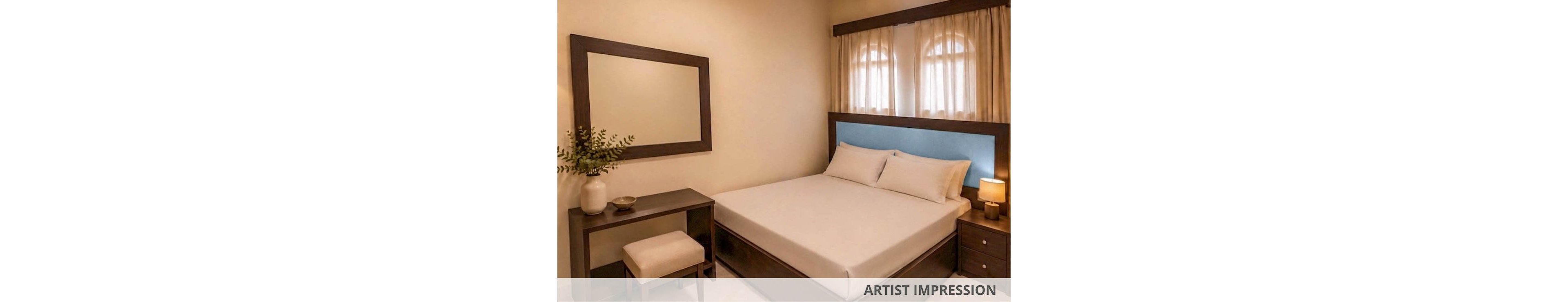 A neatly made double bed with white linens sits against a light blue upholstered headboard in a compact bedroom. Warm ambient lighting from a bedside lamp and ceiling lights creates a cozy atmosphere. A dark wooden nightstand, matching desk, and cushioned stool add contrast to the neutral walls. A large wall mirror and simple decor, including a vase with greenery, complete the minimalist interior design.